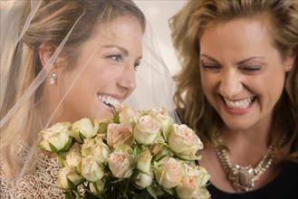 Close up of bride and maid of honor laughing