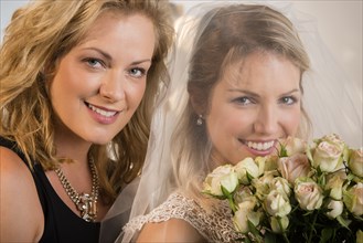 Close up of bride and maid of honor smiling