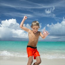 Hispanic boy playing on beach
