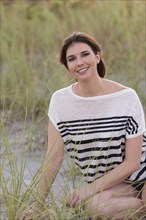 Caucasian woman smiling on beach