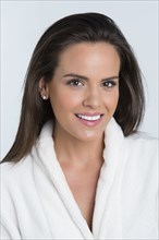 Hispanic woman smiling in bathrobe