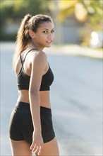 Mixed race teenage girl walking outdoors