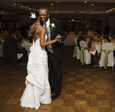 African bride and father dancing at wedding reception