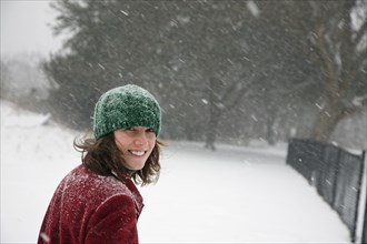 Caucasian woman walking in snow storm
