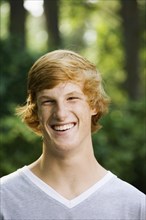 Grinning red haired teenage boy