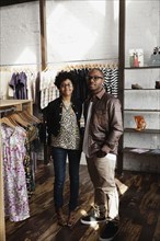 Couple standing together in clothing store
