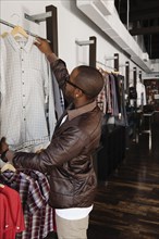 African American man shopping in clothing store