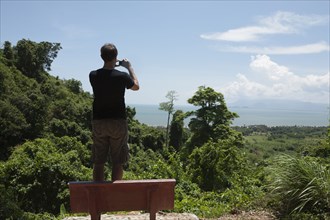 Caucasian man taking photograph of remote area