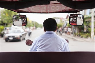 Cambodian rickshaw driver on street
