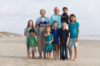 Happy multi-generation family enjoying beach together