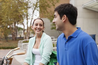 Smiling students talking on campus