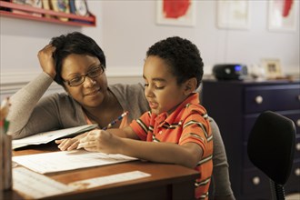 Mother helping son with homework