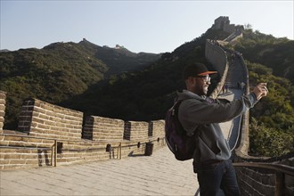 Black man taking picture on Great Wall of China