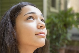 Mixed race girl looking up