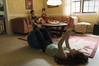 Mixed race family relaxing in living room