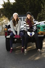 Women sitting together in truck bed