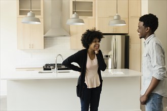 Couple talking in kitchen in new house