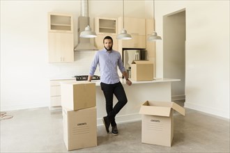 Mixed race man standing in new house
