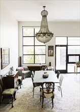 Chandelier over dining table and chairs in dining room