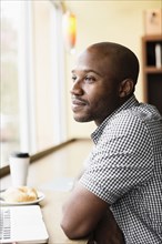Black man relaxing in coffee shop