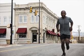 Black man running on city street