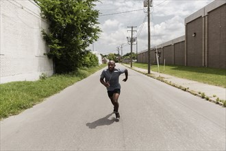 Black man running on city street