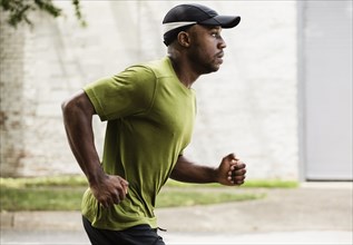 Black man running on city street