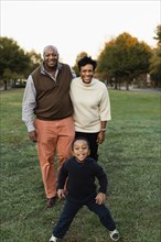 African American family smiling in park