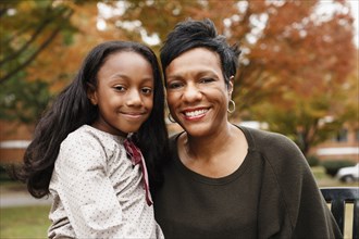 Close up of African American mother and daughter smiling