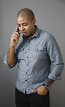 Mixed race man talking on cell phone