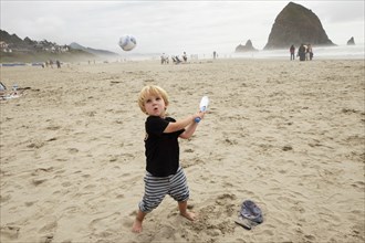 Caucasian boy playing on beach