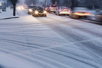 Traffic driving on snowy street