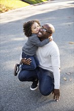 Boy hugging father outdoors