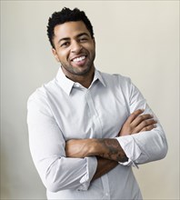 African American businessman smiling with arms crossed