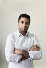 African American businessman smiling with arms crossed