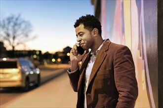 African American businessman talking on cell phone outdoors