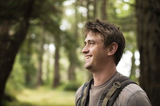 Caucasian man smiling in forest