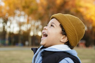 Mixed Race boy laughing in park