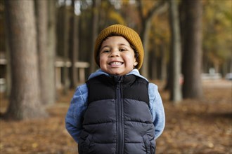 Portrait of smiling Mixed Race boy in park