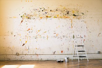 Paint splattered on wall near ladder