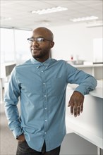 Smiling African American man leaning in office