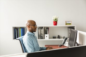 African American man using computer in office