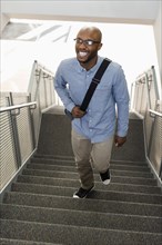 African American man climbing staircase