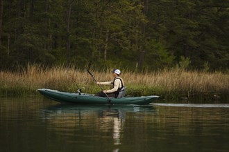 Caucasian man fishing on kayak