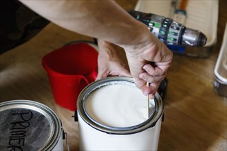Hand of native American woman stirring paint