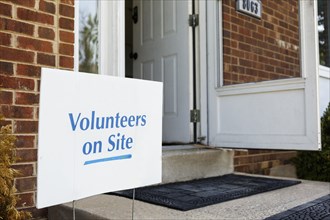 Volunteers sign on front stoop