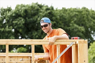 Caucasian man hammering at construction site