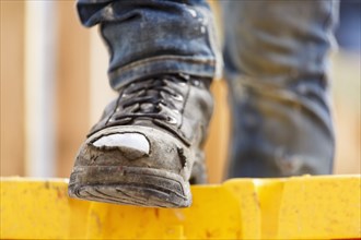 Warn boot of Caucasian woman at construction site
