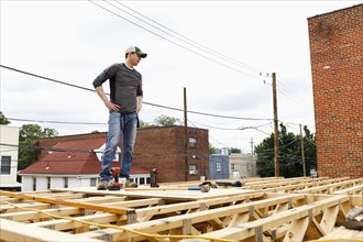 Caucasian man standing on the roof construction site