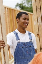 Mixed race man smiling at construction site